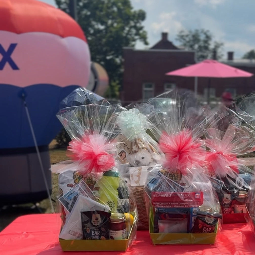 Gift baskets on a table with a large balloon in the background