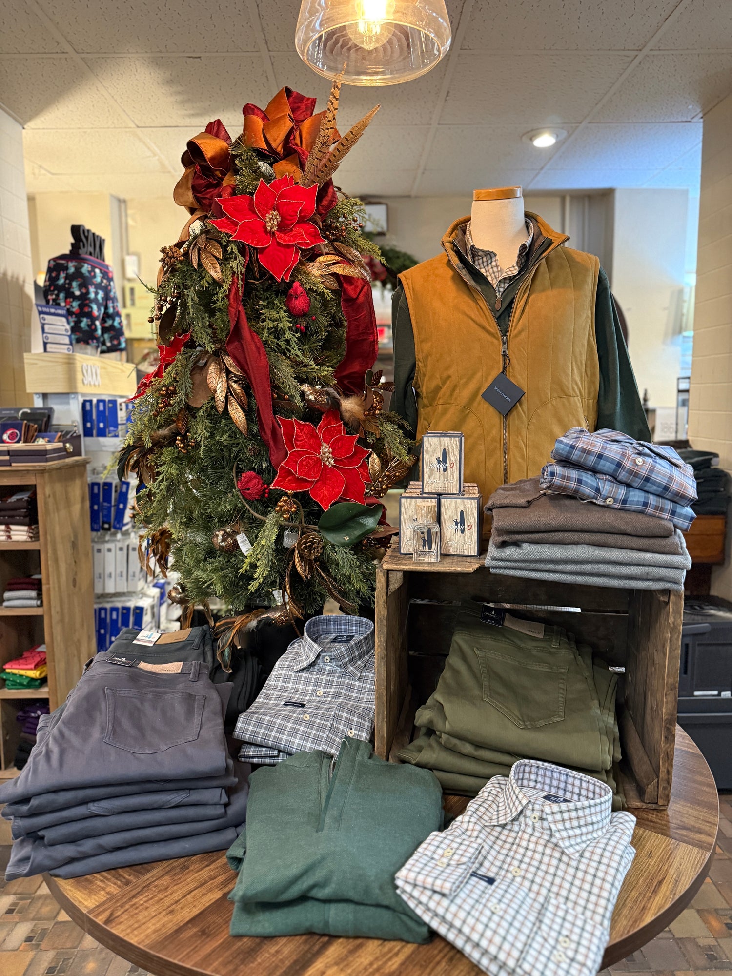 jackets and sweaters from Johnnie-o mens brand on table display at mens boutique. 